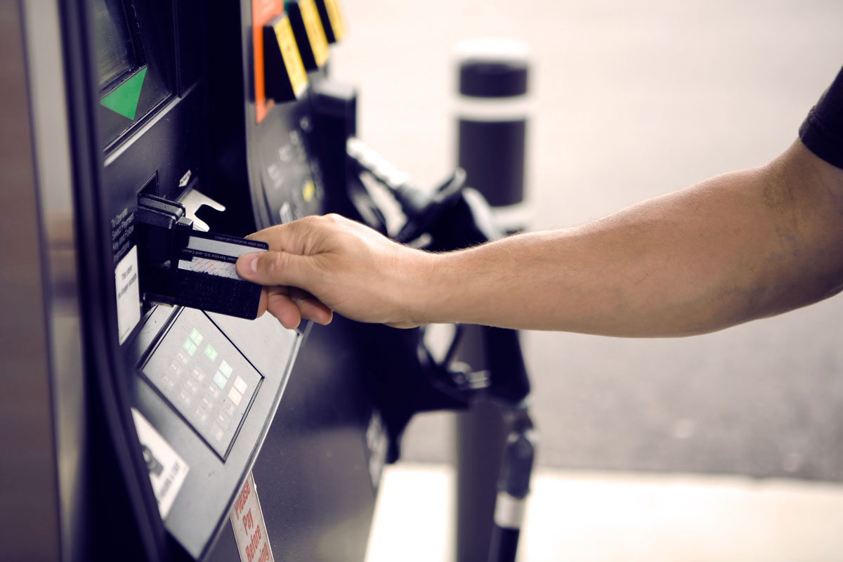 Person paying at gas pump